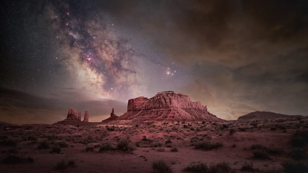 A mountain with a sky filled with stars