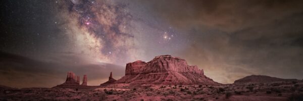 A mountain with a sky filled with stars