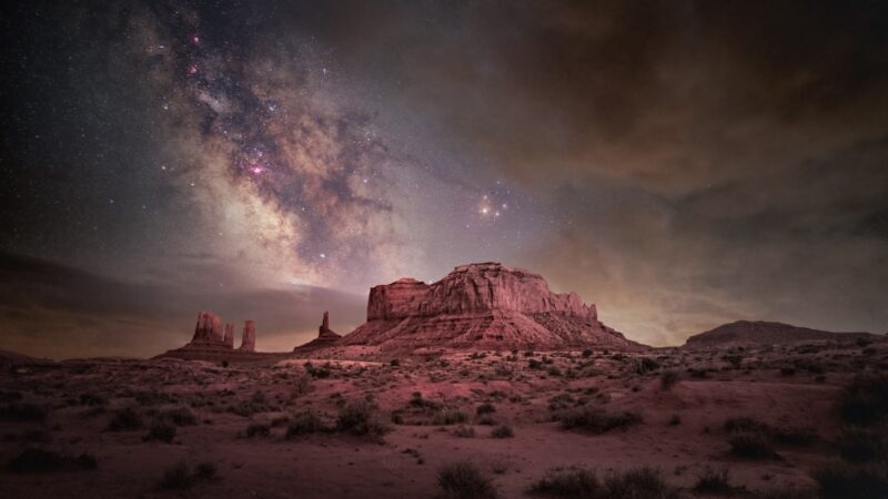 A mountain with a sky filled with stars